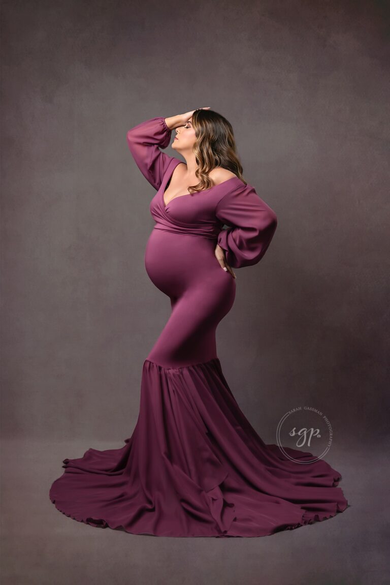 Gorgeous mama to be in mauve colored, long mermaid style dress at fine art maternity photoshoot in Houston, Texas. Houston maternity photographer