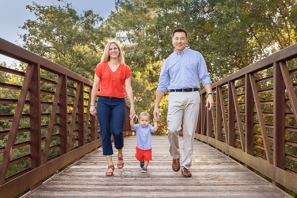 Family photos on bridge with blue khaki and orange color palette family photos Houston TX, Houston family photographer