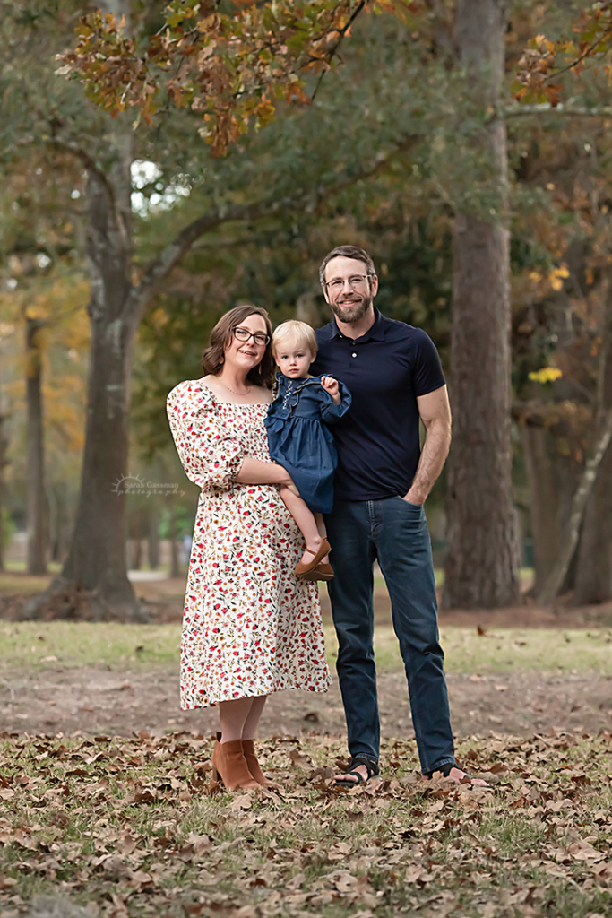 family dressed in fall colors for outdoor photoshoot in Cypress, Texas