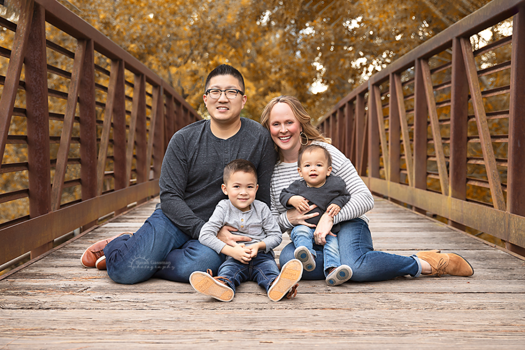 family of four on a bridge fall family photos Houston TX