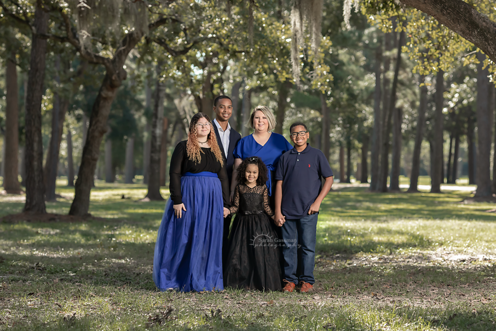 Family photos standing under big trees with moss, royal blue navy blue and black color palette family photos Cypress TX