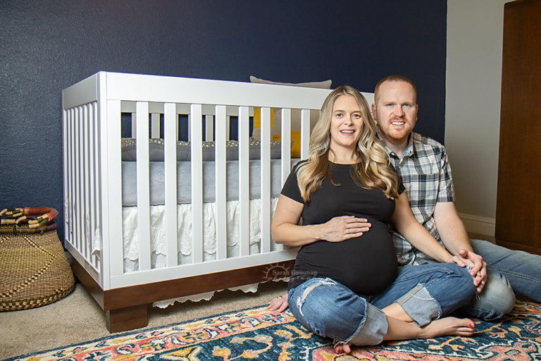 in-home maternity session parents to be in front of crib in nursery Houston TX, Cypress Texas maternity photographer