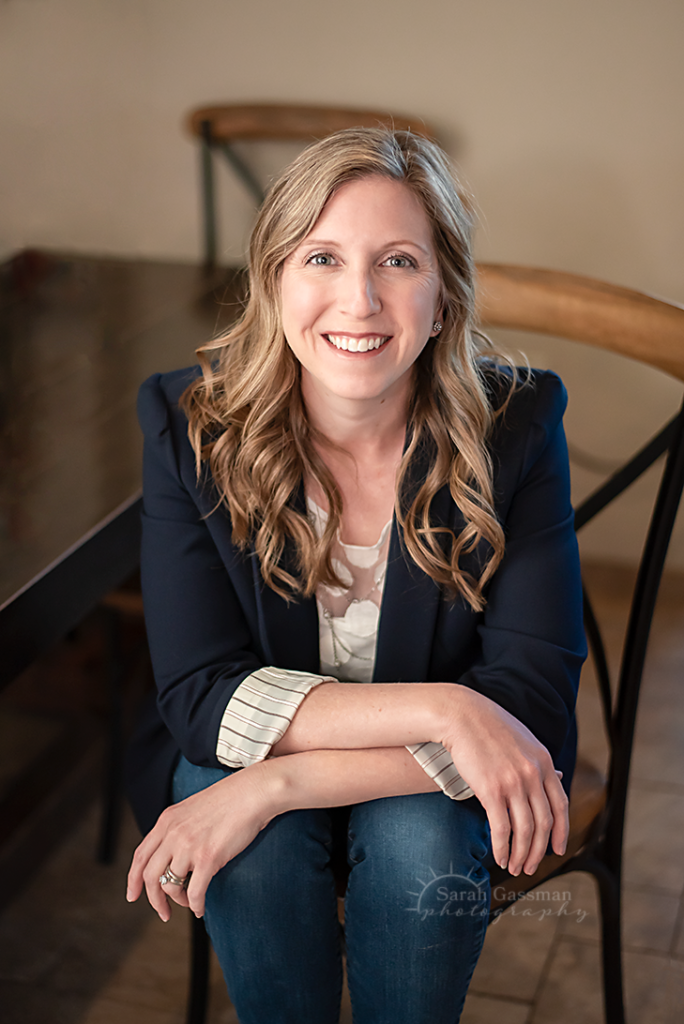 portrait photographer sits casually for a headshot photo