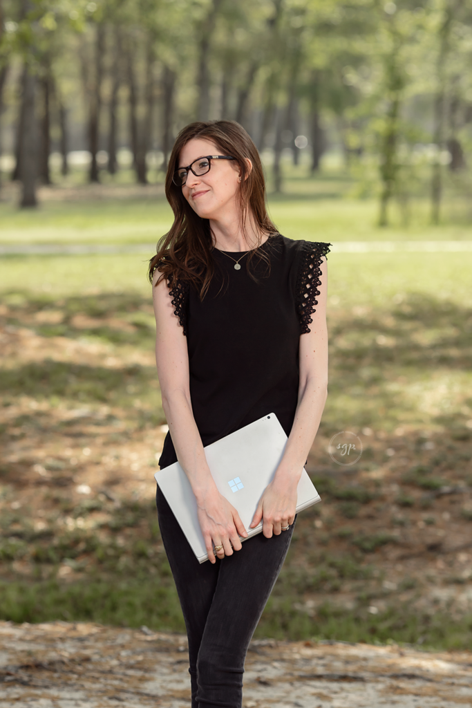 Woman in all black with laptop taken at branding photo session near Houston Texas