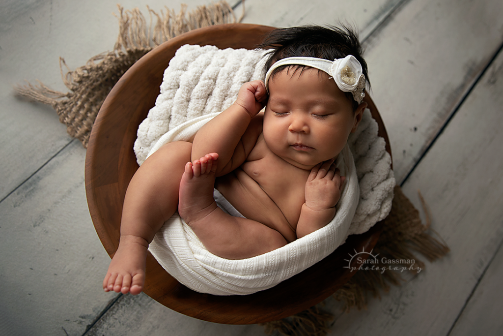 baby girl sleeping in bowl at in-home newborn photo session, Cypress Texas newborn photographer