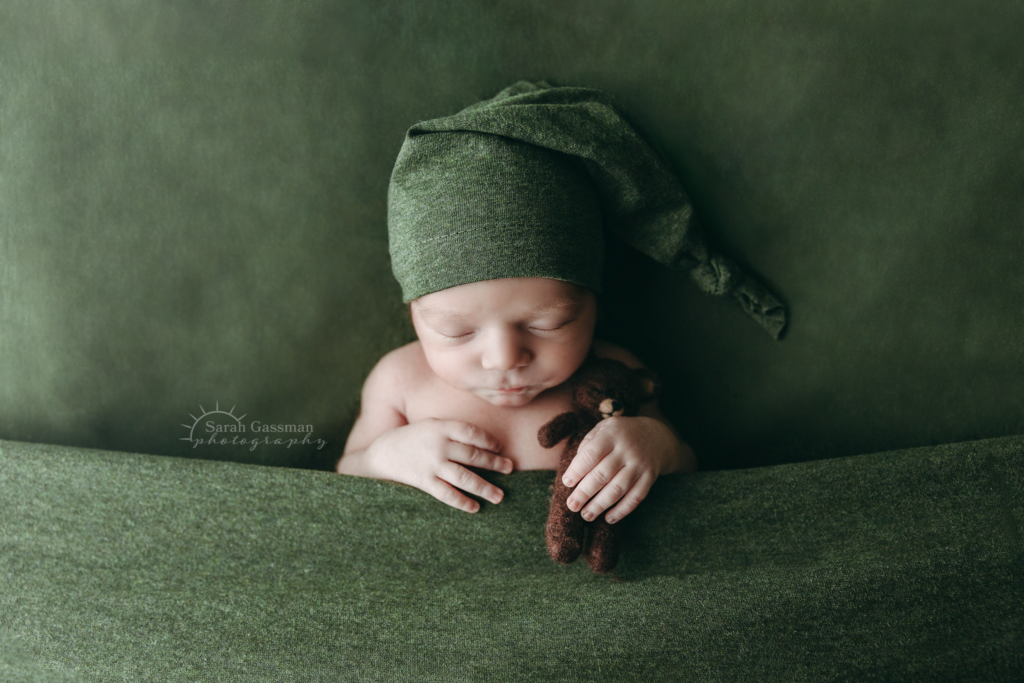 baby sleeping tucked in pose at in-home newborn photo session, Katy newborn photographer