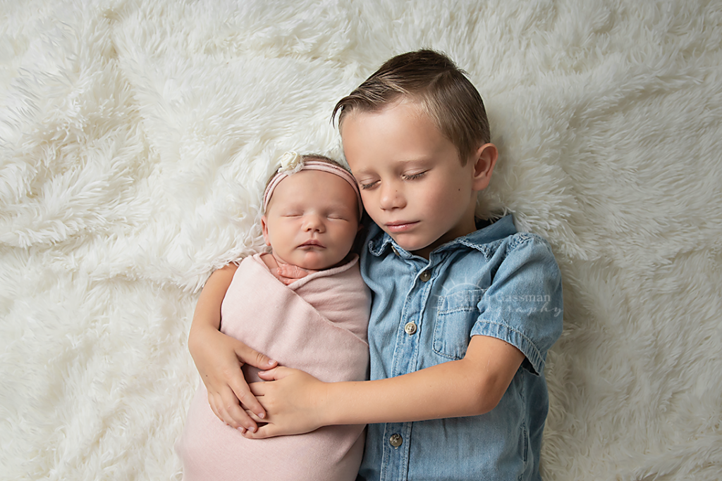 big brother sleeps with new baby sister, newborn photo session in client home, Houston newborn photographer