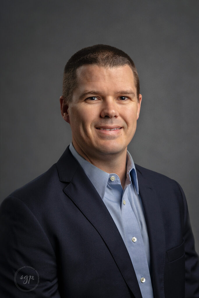 corporate headshot of man in blue oxford and navy blazer by Houston headshot photographer