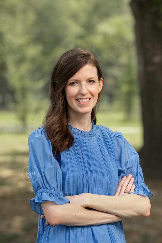 branding session of woman in blue shirt in a wooded, natural area