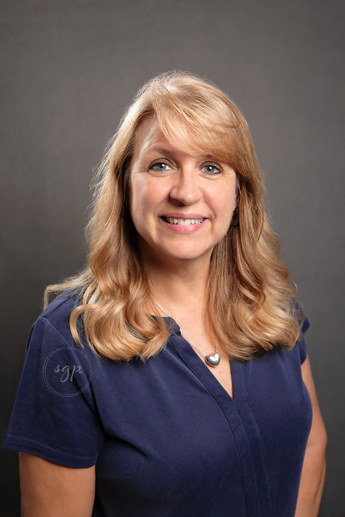 Houston headshot of woman in blue dress with blonde hair