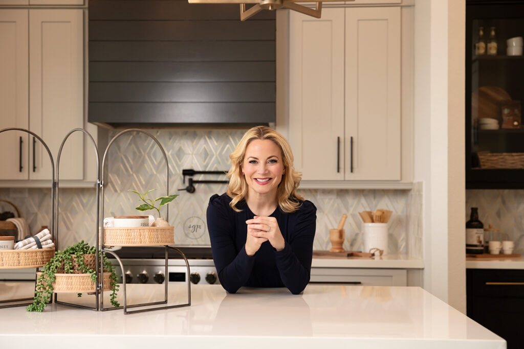 headshot image of realtor in navy blue dress in a model home in Cypress Texas