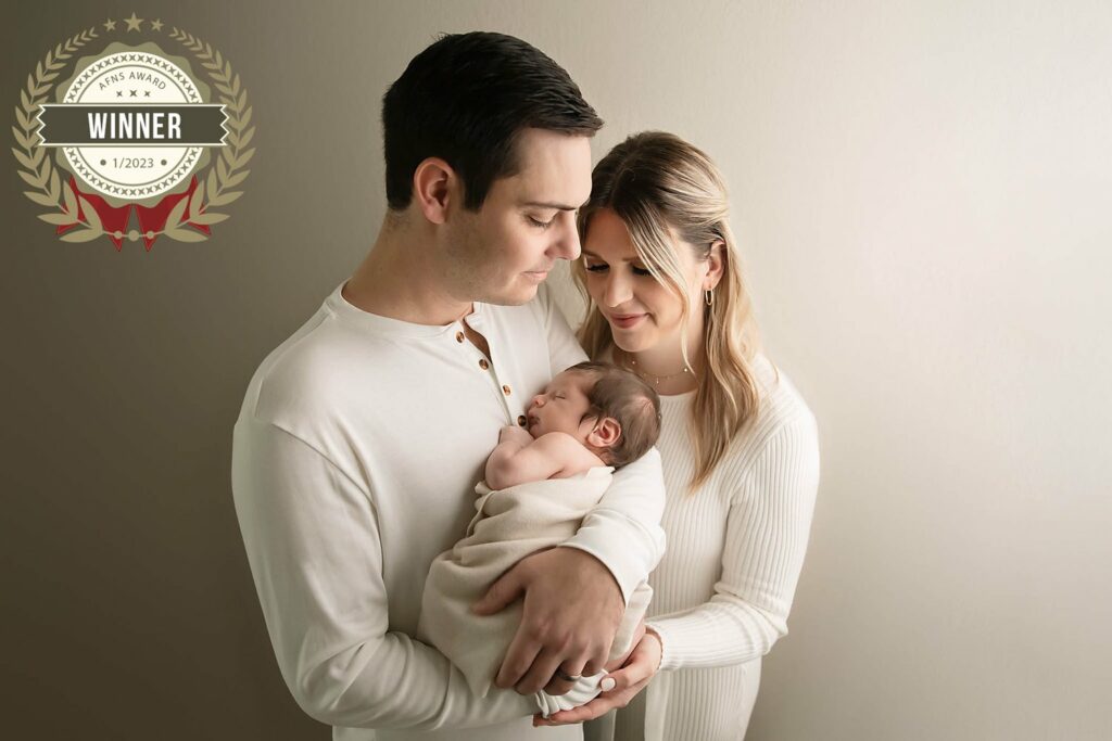 award winning photo of family's first photo at in-home luxury newborn photo session, Cypress Texas newborn photographer, Cypress newborn portraits