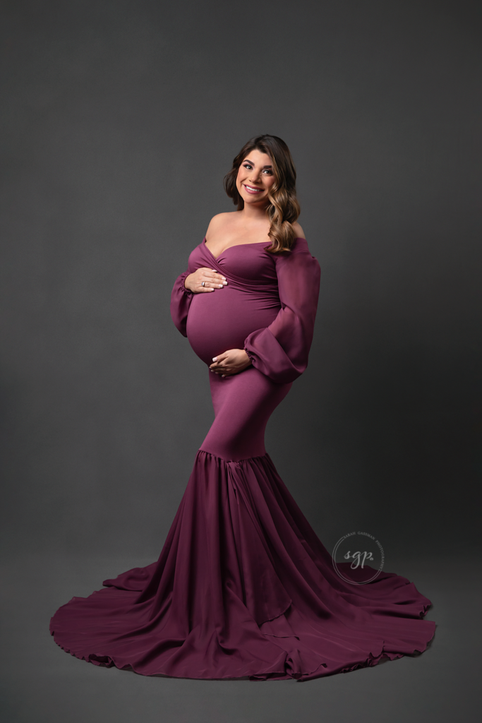 maternity photo of mama to be in long mermaid style mauve colored dress, Houston maternity photographer