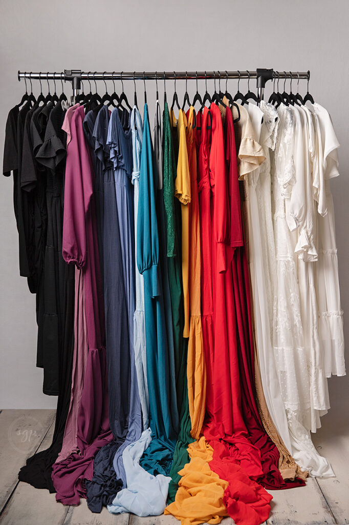 rack full of colorful dresses for maternity and postpartum for photo sessions