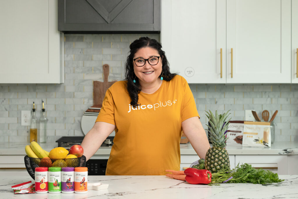 woman in kitchen advertising JuicePlus+ in branding photo