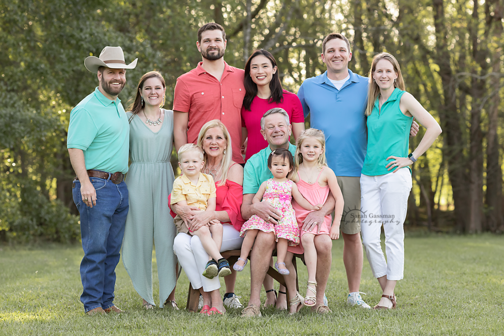 Extended family takes brightly colored themed family photo when one household visits from Asia. Taken near Houston in the Spring time.