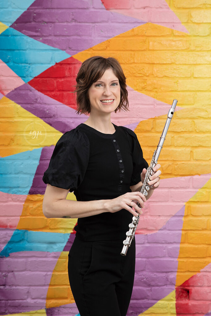 Bright and bold colored headshot of female flutist