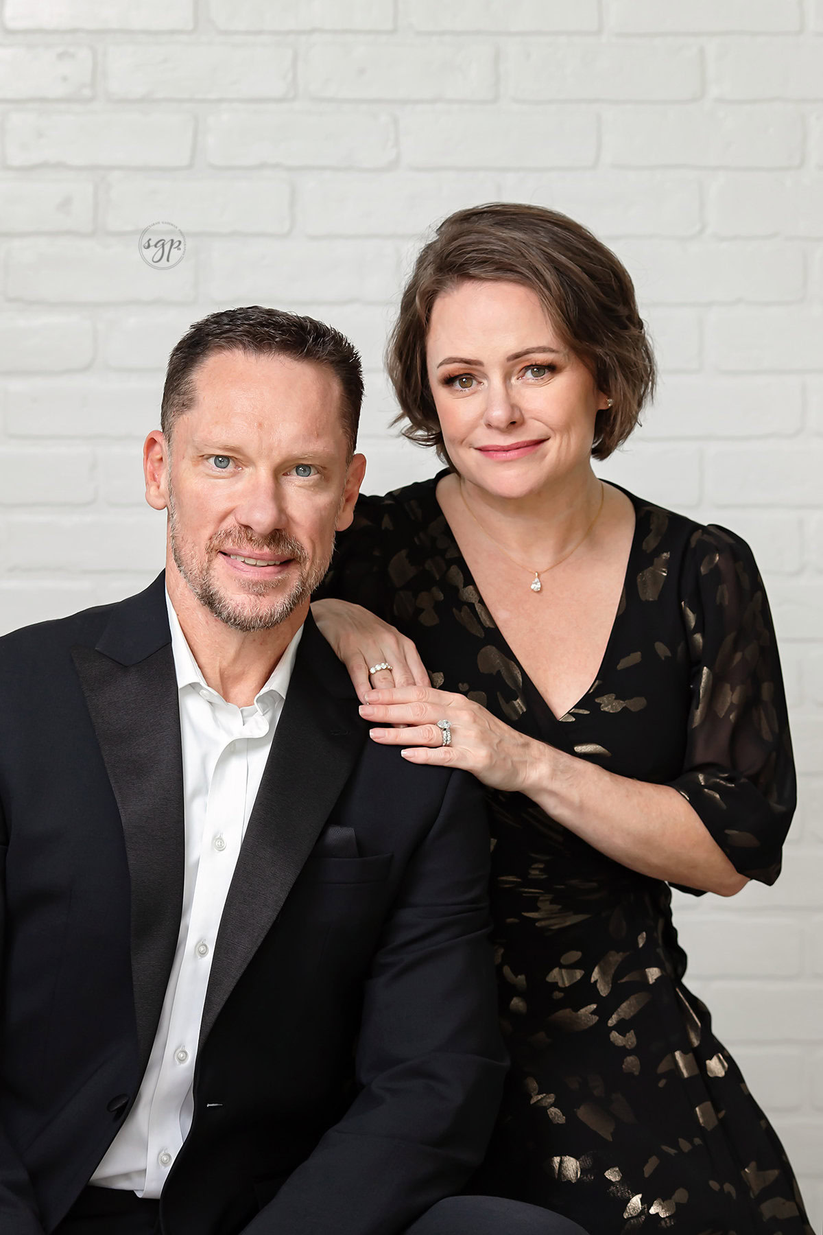 Couples Photo session close up man in tux woman in black and gold dress
