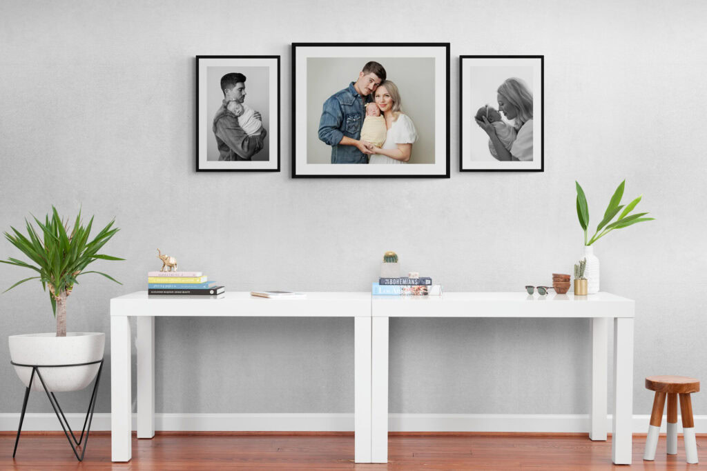 wall art photos of mom dad and baby hung in house from newborn photo session